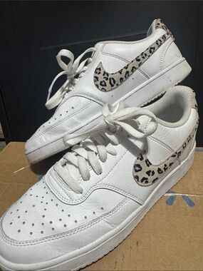 Nike Women’s White Leather Sneakers with Leopard Swoosh Accent